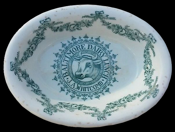 Plate, similar to example shown from diner named “Baltimore Dairy Lunch”. Unglazed bisque waster. Transfer printed in dark green. Rim diameter: 6.75”; 4.1 mm thick. Impressed mark on reverse:Maddock’s ….n [Trenton] China.